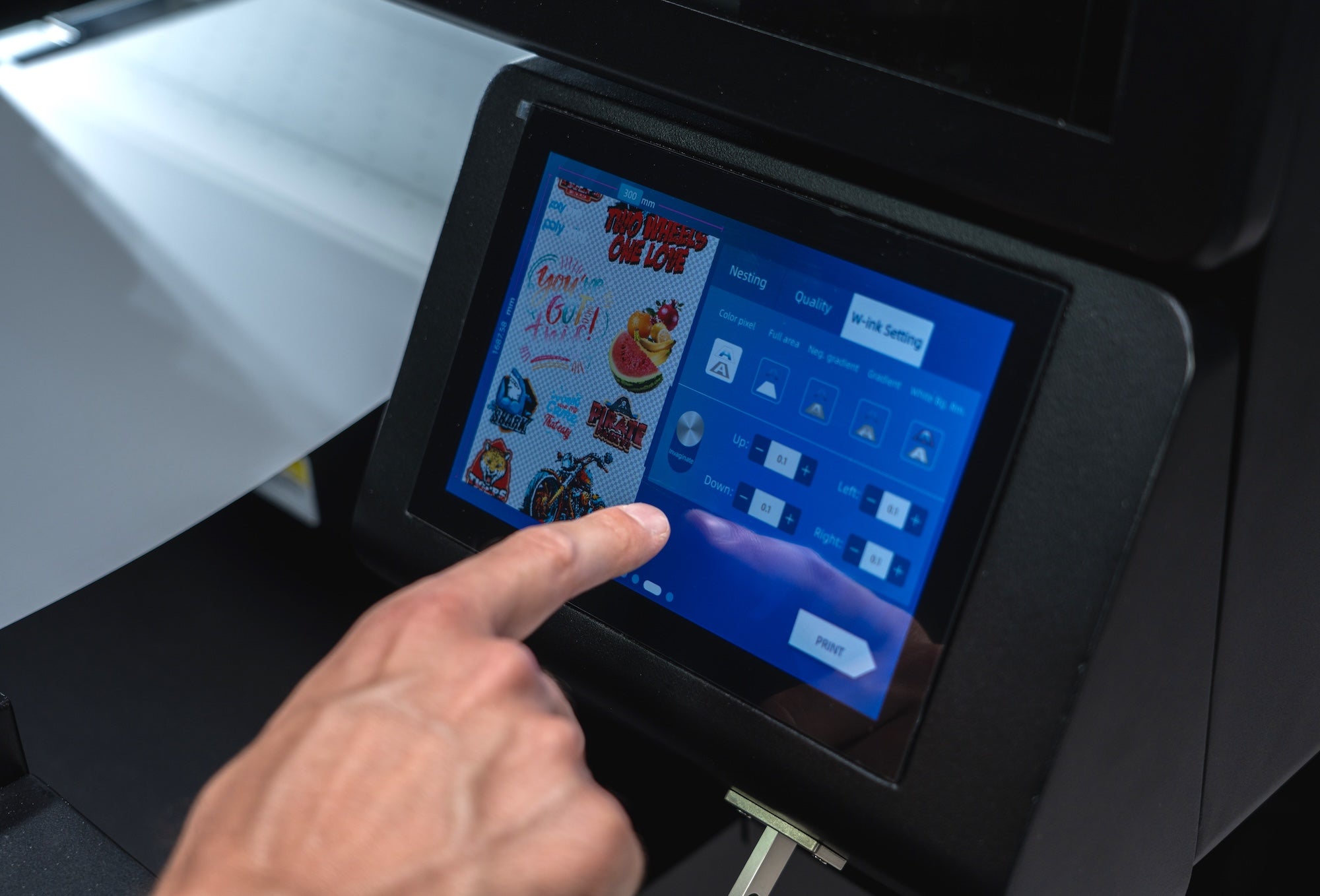 Person interacting with the touchscreen of the Filmjet Mini DTF printer displaying various options.