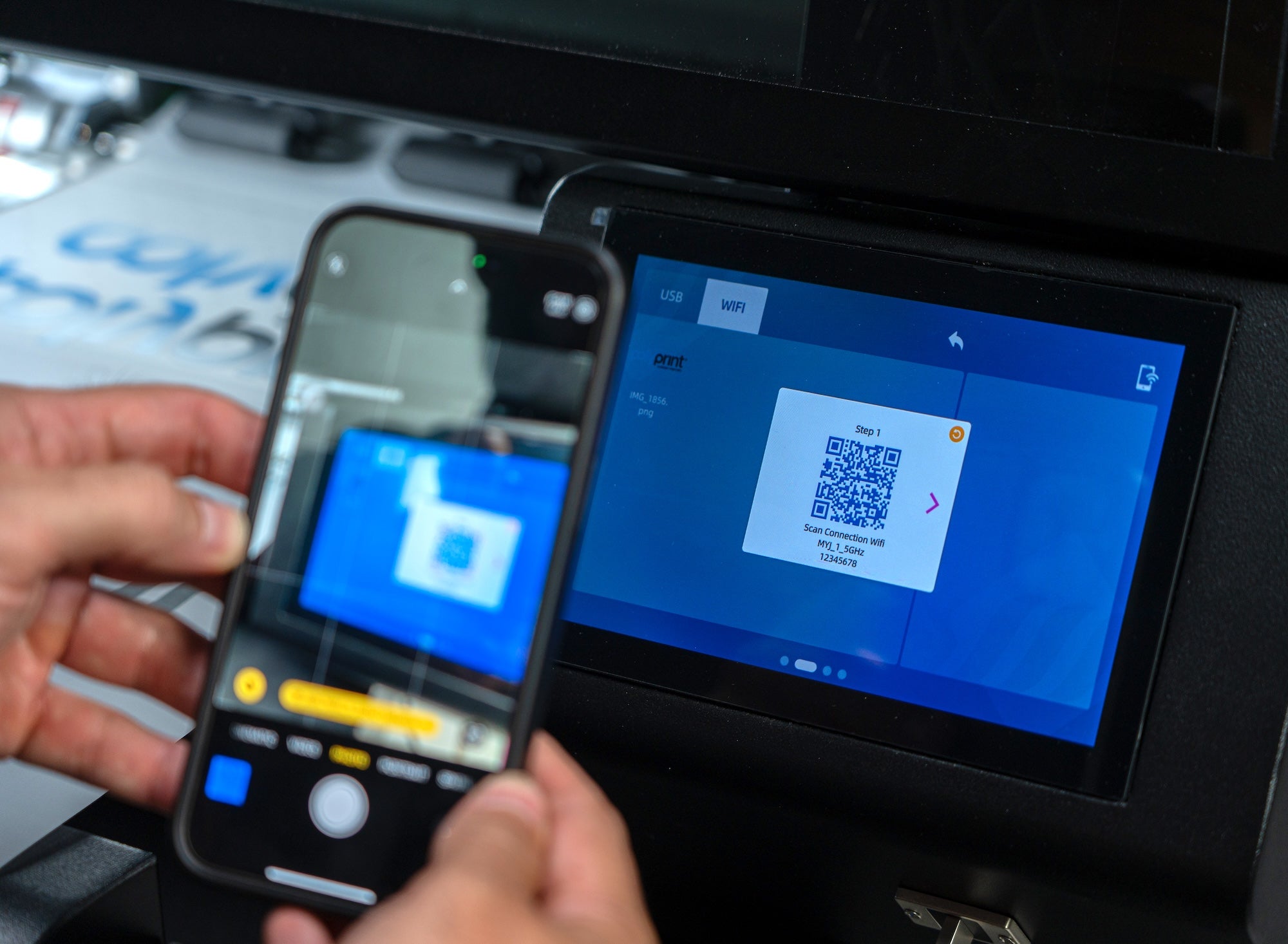 Person using smartphone to add images via wifi to Filmjet Mini DTF printer